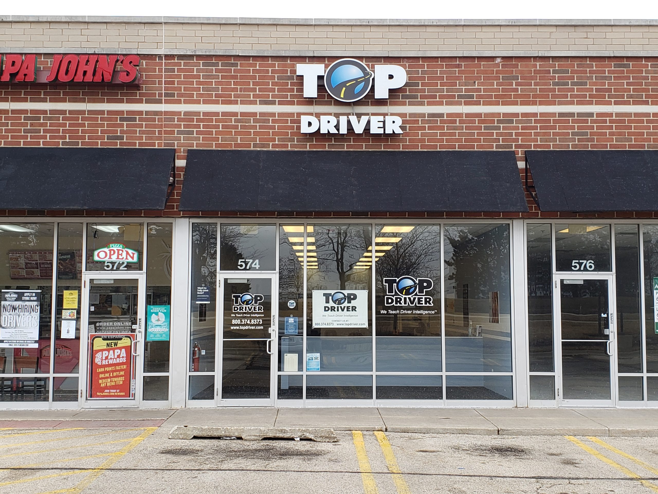 top driver store front next to papa johns