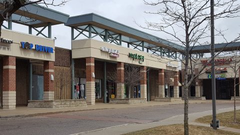Shopping center with Top Driver store front.