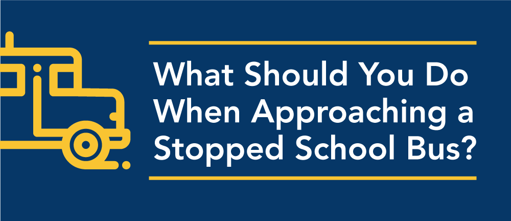 What should you do when approaching a stopped school bus in Illinois?
