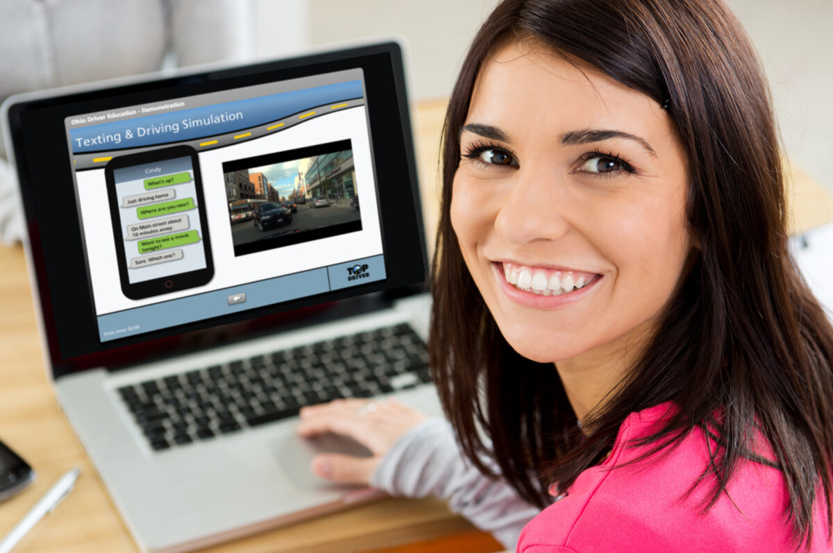 woman taking an online top driver course on a laptop